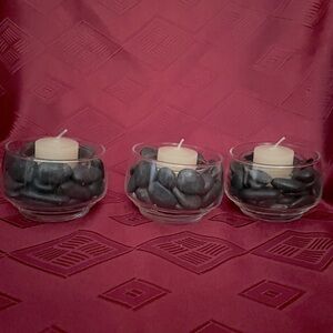 3 votive candle holders perched in black pebbles set in vintage glass dish